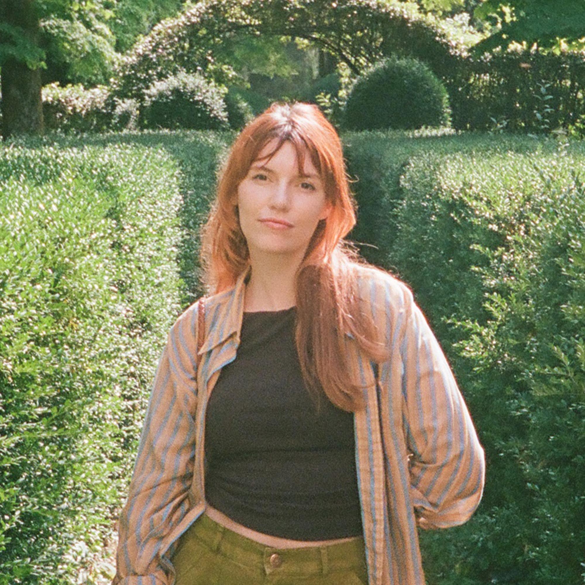 Cora Nimtz poses for a photo in a garden.