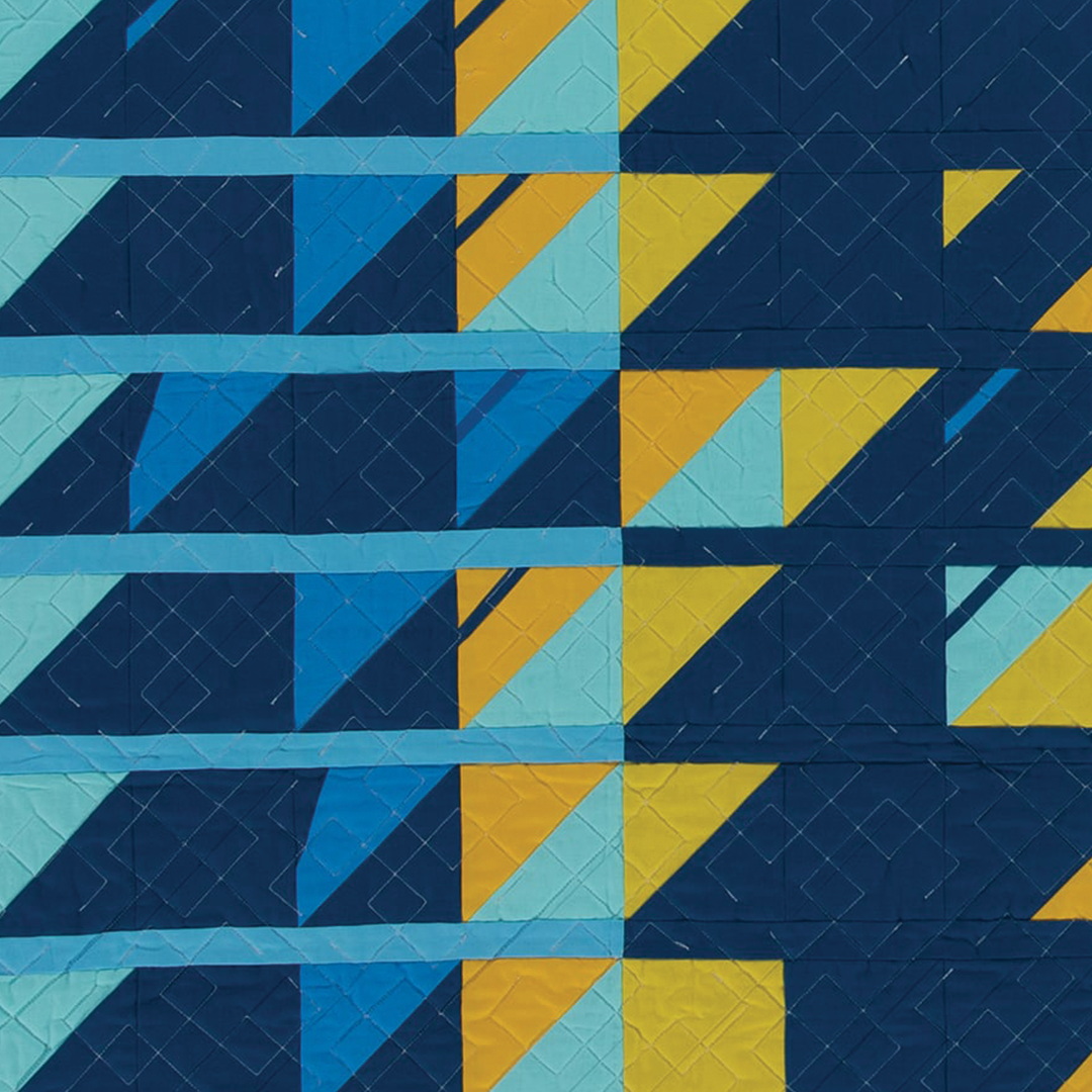 Song quilt photo showing a pattern in blues and yellows. 