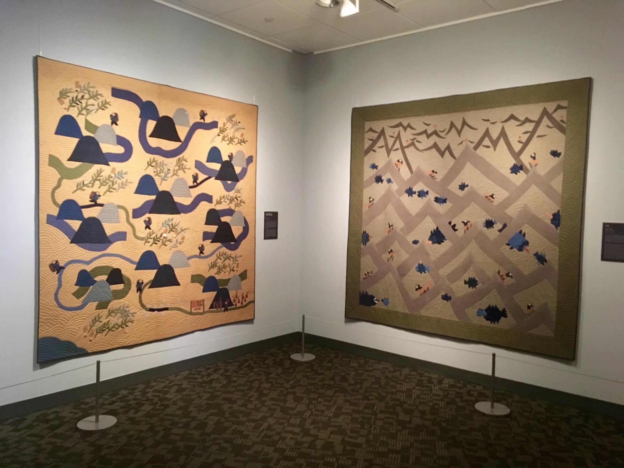 Two Rumi O'Brien quilts on display in a gallery.
