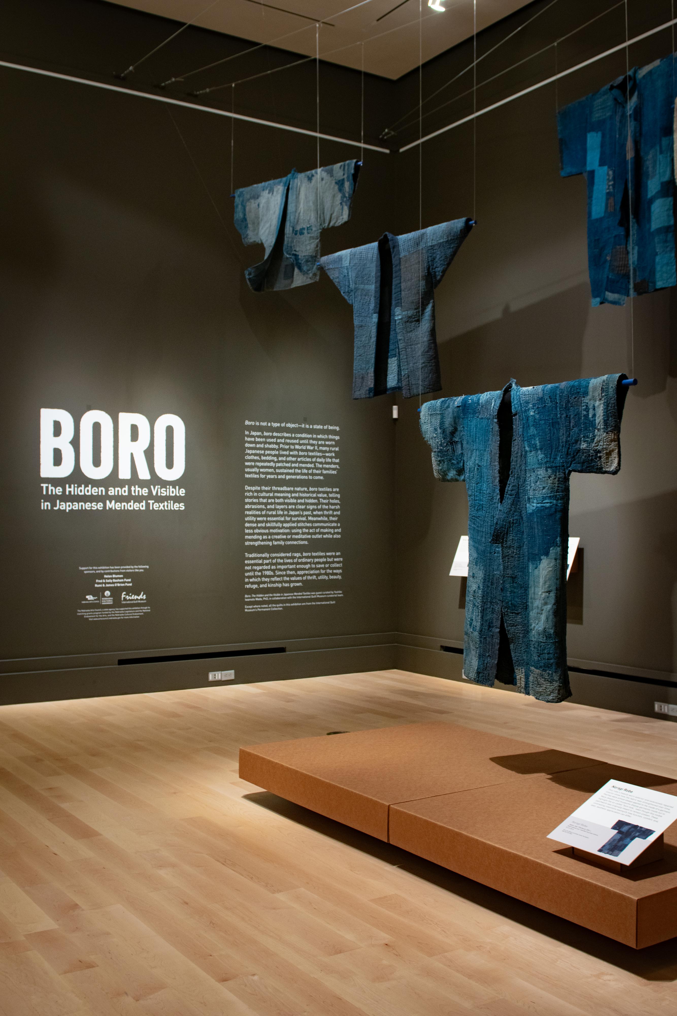 BORO: The Hidden and the Visible in Japanese Mended Textiles "Boro" exhibition with pieces suspended from the ceiling.