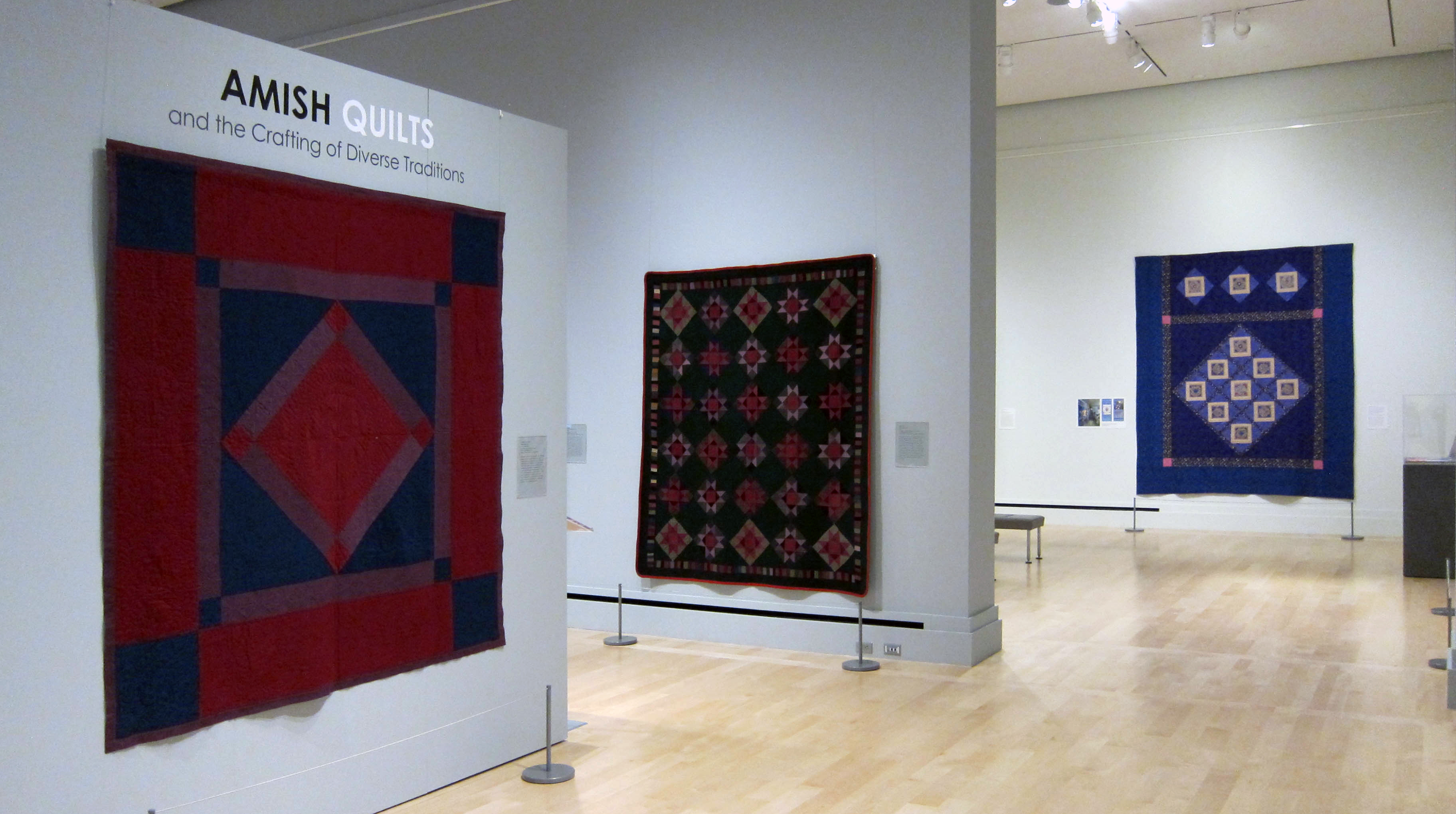 Crafting Diverse Traditions gallery photo photo of Amish quilts hanging in Crafting Diverse Traditions